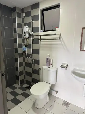 a bathroom with a toilet and a sink at KH Water Park Manhattan Condo Ipoh Homestay in Kampong Pinji