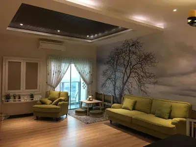a living room with a couch and a table at Pearl Rice Garden \uff08cottage style\uff09\u7c73\u6a02\u574a\u9802\u5c64\u7530\u56ed\u5f0f\u9ad8\u7ea7\u516c\u5bd3 in Sekincan