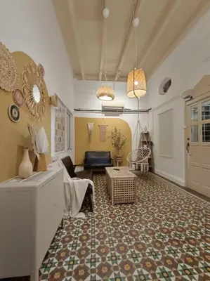 a living room with a couch and a table at UNESCO Bohemian Style Heritage House at Georgetown 5BR 14 pax in George Town