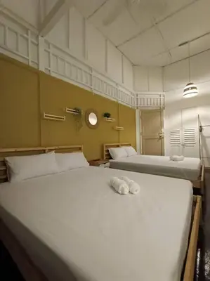a bedroom with two beds with towels on it at UNESCO Bohemian Style Heritage House at Georgetown 5BR 14 pax in George Town