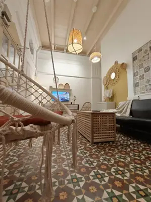 a room with a staircase and a living room at UNESCO Bohemian Style Heritage House at Georgetown 5BR 14 pax in George Town