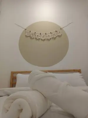 a bedroom with a bed with a light above it at UNESCO Bohemian Style Heritage House at Georgetown 5BR 14 pax in George Town