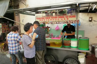a group of people standing in front of a food cart at UNESCO Bohemian Style Heritage House at Georgetown 5BR 14 pax in George Town