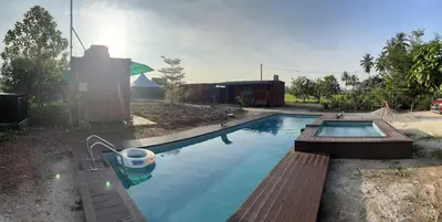 a swimming pool in the backyard of a house at HOMESTAY Kampong KOTA AUR Resort with swimming pool, Kepala Batas, SEBERANG PERAI, PENANG -MOTAC registered Awarded ASEAN homestay standard Malaysia AWARD 2023-2028 Only 3 minutes from viral KG AGONG in Kepala Batas