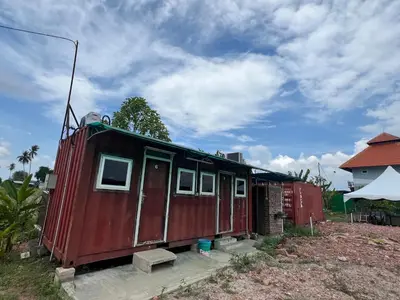 a red tiny house sitting in a yard at HOMESTAY Kampong KOTA AUR Resort with swimming pool, Kepala Batas, SEBERANG PERAI, PENANG -MOTAC registered Awarded ASEAN homestay standard Malaysia AWARD 2023-2028 Only 3 minutes from viral KG AGONG in Kepala Batas