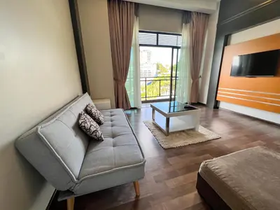 a living room with a couch and a tv at Hotel Studio Apartment- Fantastic Mountain View (4pax) in Brinchang
