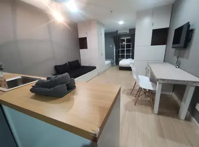 a kitchen and living room with a table and a couch at Kampar Bonvoy Champs Elysees 4pax Homestay in Kampar