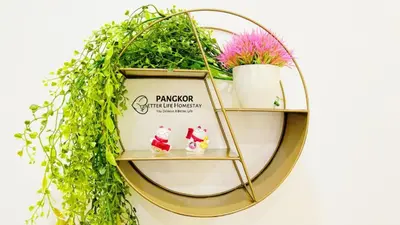 a gold circle shelf with plants on it at Pangkor Better Life Minimalist Beach Villa-13 to15pax Free WiFi in Pangkor