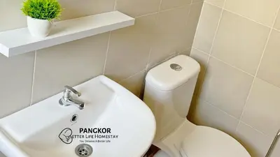 a bathroom with a white toilet and a sink at Pangkor Better Life Minimalist Beach Villa-13 to15pax Free WiFi in Pangkor