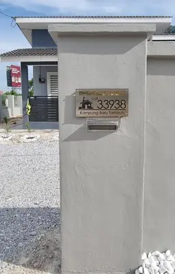 a sign on the side of a building at Tambun Hillview Cottage 1 in Tambun