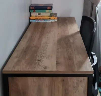 a wooden table with a stack of books on it at Tambun Hillview Cottage 1 in Tambun