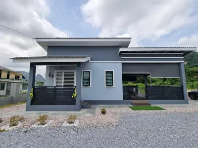 a white house with black doors and a driveway at Tambun Hillview Cottage 1 in Tambun