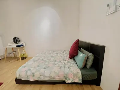 a bedroom with a bed and a chair at Cozy 10 Entire House 4 Bedroom At Alma Bukit Mertajam in Bukit Mertajam