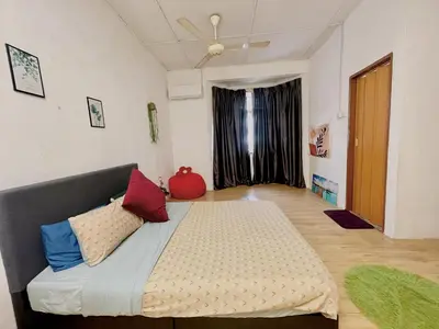 a bedroom with a large bed with pillows on it at Cozy 10 Entire House 4 Bedroom At Alma Bukit Mertajam in Bukit Mertajam