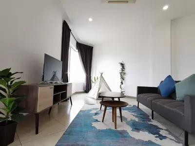 a living room with a couch and a table at Octagon Ipoh Family Suites in Ipoh