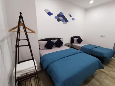 a room with two beds and a ladder at Octagon Ipoh Family Suites in Ipoh