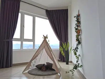 a room with a tent in front of a window at Octagon Ipoh Family Suites in Ipoh