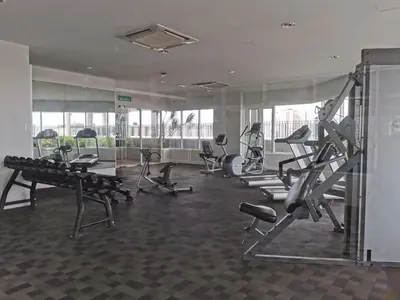 a gym with treadmills and machines in a room at Octagon Ipoh Family Suites in Ipoh