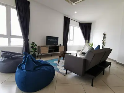 a living room with a couch and a chair at Octagon Ipoh Family Suites in Ipoh