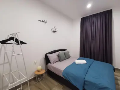 a bedroom with a bed with blue sheets and a ladder at Octagon Ipoh Family Suites in Ipoh