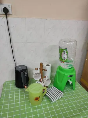 a kitchen counter with a green blender and cups at Mai KKB Homestay in Kuala Kubu Bharu Taman Juta in Kuala Kubu Baharu