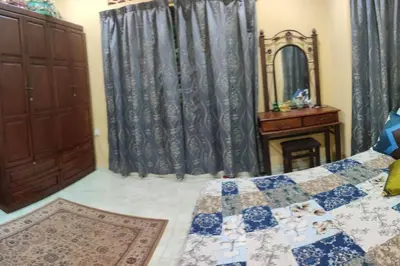 a bedroom with a bed and a dresser and a mirror at Mai KKB Homestay in Kuala Kubu Bharu Taman Juta in Kuala Kubu Baharu