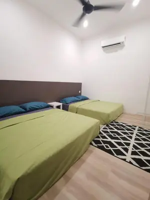 a bedroom with two beds and a ceiling fan at Wellson Home Ipoh 58 10px \u5168\u65b0\u94fe\u63a5\u5f0f\u6c11\u5bbf\u6709\u4e24\u95f4 in Ipoh