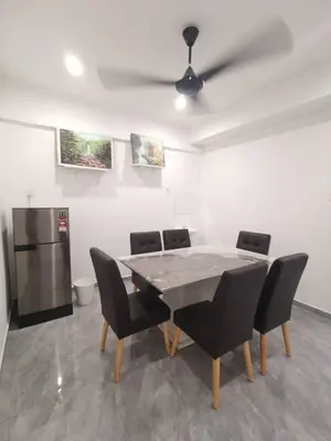a dining room with a table and chairs and a refrigerator at Wellson Home Ipoh 56 10px \u5168\u65b0\u94fe\u63a5\u5f0f\u6c11\u5bbf\u6709\u4e24\u95f4 in Ipoh