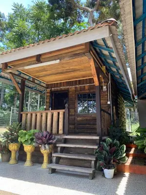 a small wooden cabin with stairs leading to the door at HOMESTAY DUSUN ANA BALUN in Slim River