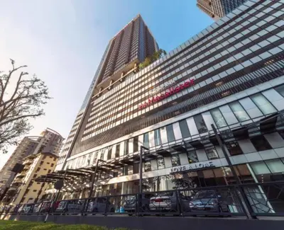 a large building with cars parked in front of it at SOPHIA'S HOME - CITY and HILL VIEW 3BR at 218 Tropicana Macalister with Netflix & TV Box in George Town
