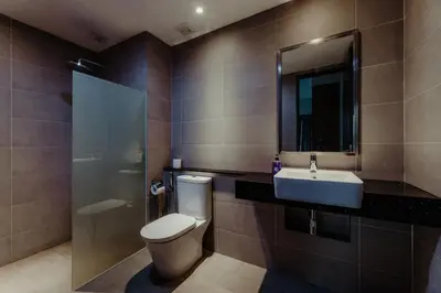 a bathroom with a toilet and a sink at SOPHIA'S HOME - CITY and HILL VIEW 3BR at 218 Tropicana Macalister with Netflix & TV Box in George Town