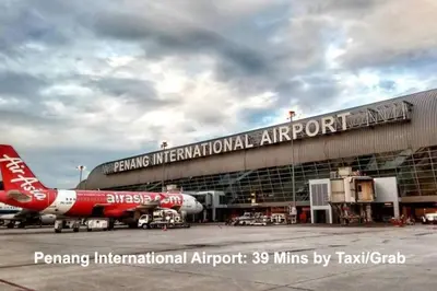 an airport with a red airplane parked on the tarmac at SOPHIA'S HOME - CITY and HILL VIEW 3BR at 218 Tropicana Macalister with Netflix & TV Box in George Town