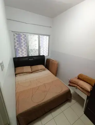 a bedroom with a bed in the corner of a room at Muslim Boutique Apartment with Balcony in Tanah Rata