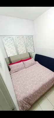 a bed in a room with a window at Muslim Boutique Apartment with Balcony in Tanah Rata