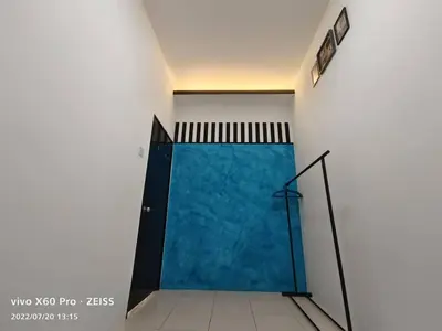 a hallway with a blue door in a building at ifloral CH1 in Tanah Rata