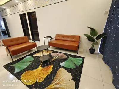 a living room with a couch and a rug at ifloral CH1 in Tanah Rata