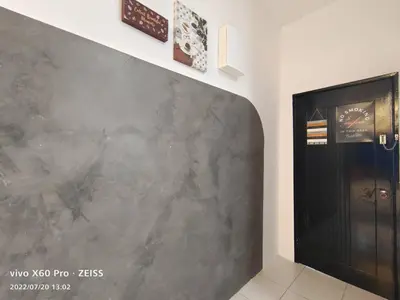 a gray wall in a room with a black door at ifloral CH1 in Tanah Rata