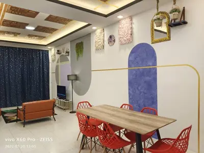 a dining room with a table and red chairs at ifloral CH1 in Tanah Rata