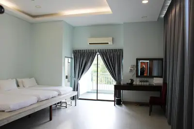 a bedroom with a bed and a desk and a window at Happy Valley Eco Farm in Kerling