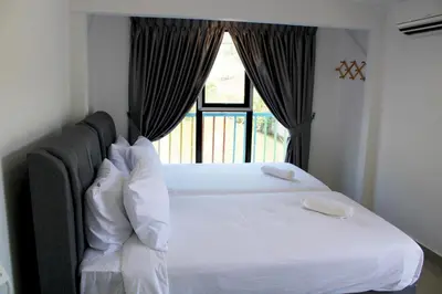 a bedroom with a large white bed with a window at Happy Valley Eco Farm in Kerling