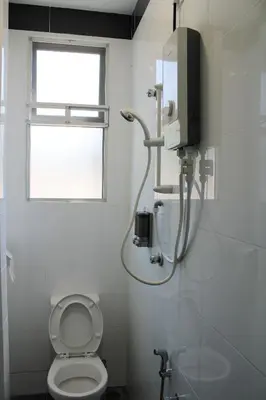 a white bathroom with a toilet and a window at Happy Valley Eco Farm in Kerling