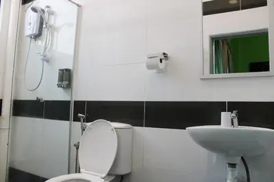 a bathroom with a toilet and a sink at Happy Valley Eco Farm in Kerling