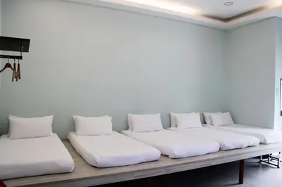 a row of white pillows sitting on a table at Happy Valley Eco Farm in Kerling