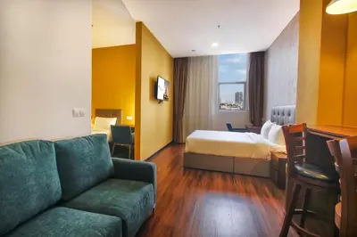 a hotel room with a couch and a bed at CitiVilla Hotel Penang in George Town