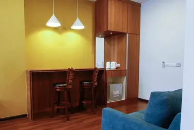 a living room with a bar and two stools at CitiVilla Hotel Penang in George Town