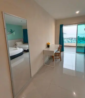 a room with a mirror and a bed and a desk at Glossy Marina Homestays in Lumut