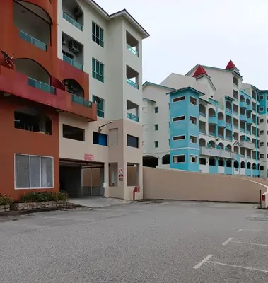 an empty parking lot in front of two buildings at Glossy Marina Homestays in Lumut
