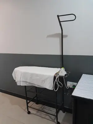 a hospital bed with a white blanket on it at V HOTEL in Teluk Intan