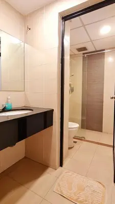 a bathroom with a shower and a sink and a toilet at PP Hotel Penang in George Town