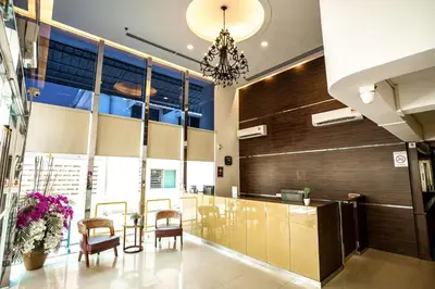 a lobby with a table and chairs in a building at PP Hotel Penang in George Town
